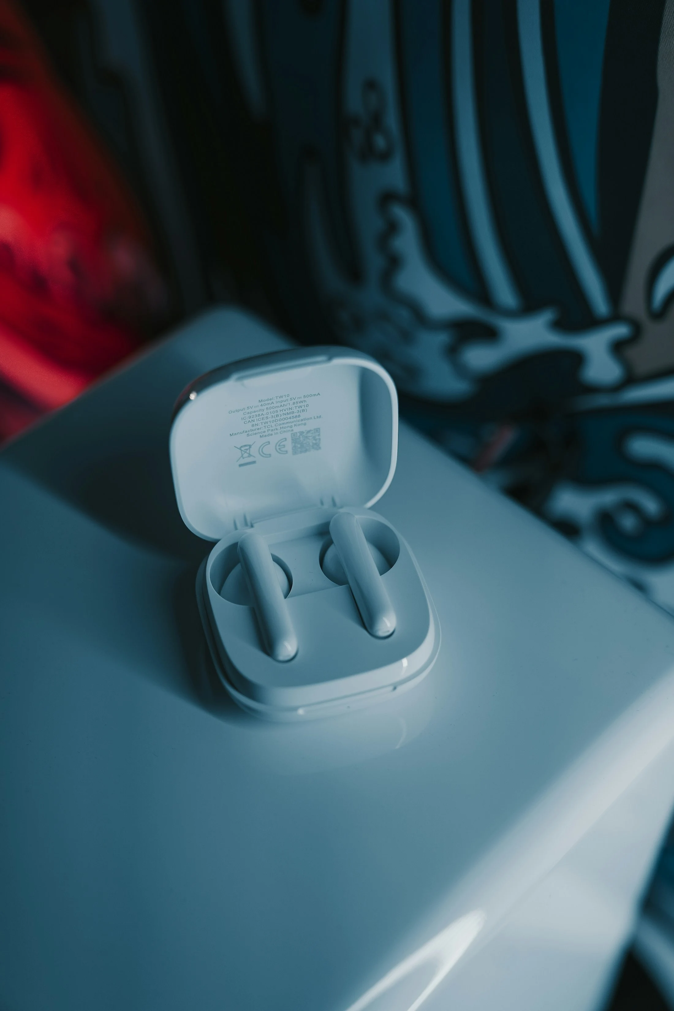 White wireless earbuds in their open charging case